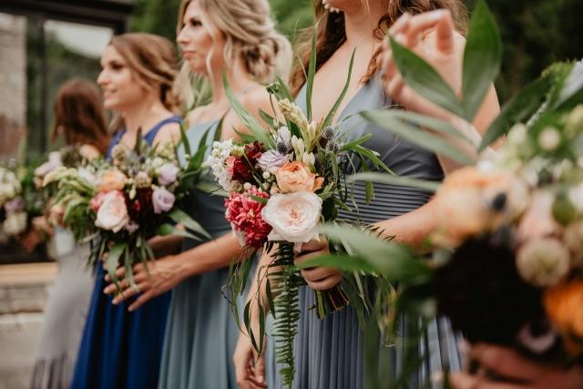 Bridesmaids at a colorful outdoor wedding.