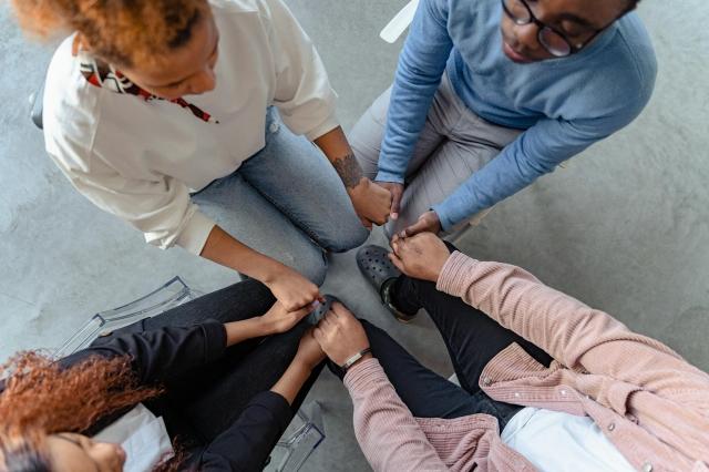 Photo by Antoni Shkraba Studio: https://www.pexels.com/photo/high-angle-shot-of-people-holding-each-other-s-hands-7579304/