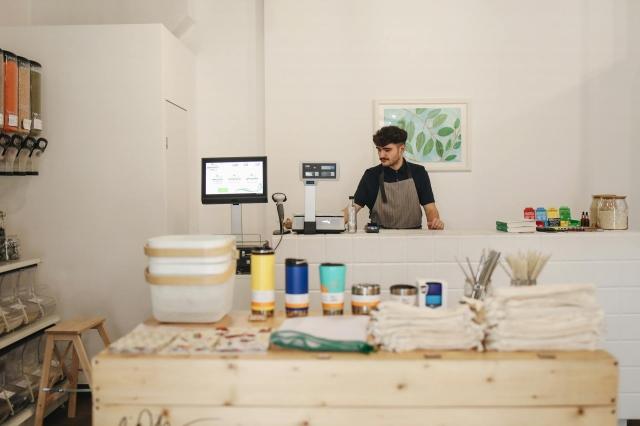 A small business owner working behind the counter